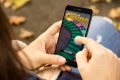 addiction concept: woman holding a 3d generated smartphone with online casino website on the screen. Graphics on screen are made up.